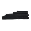 Stack of black towels on a beige background