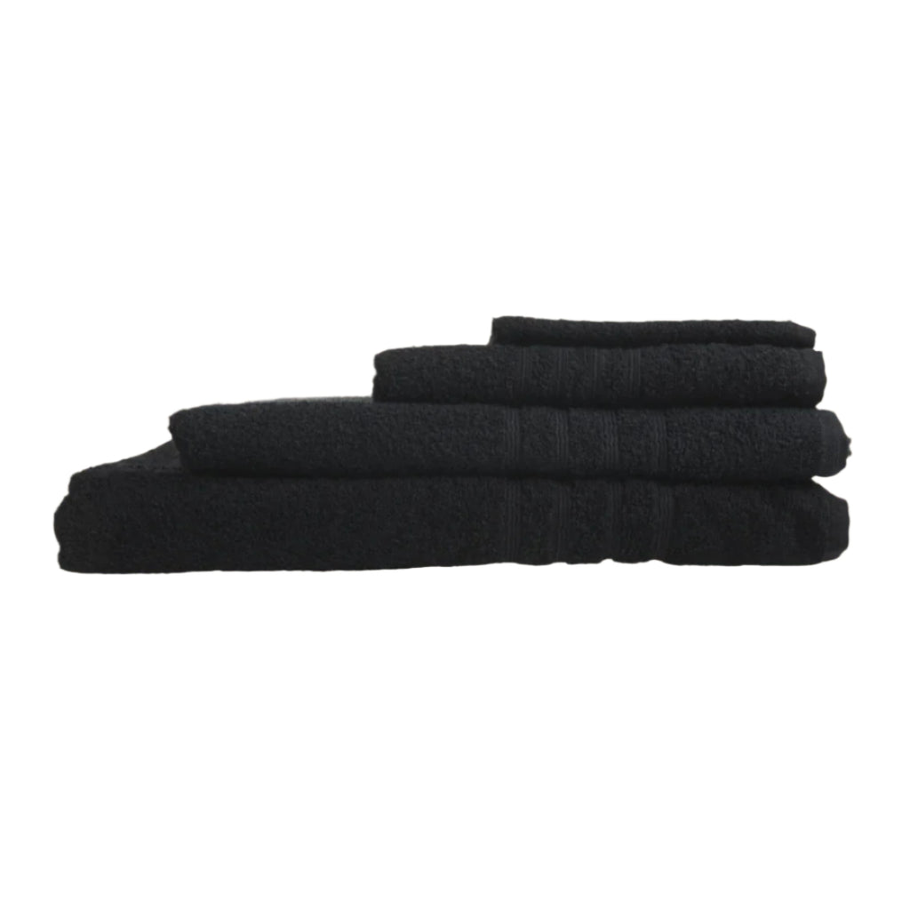 Stack of black towels on a beige background