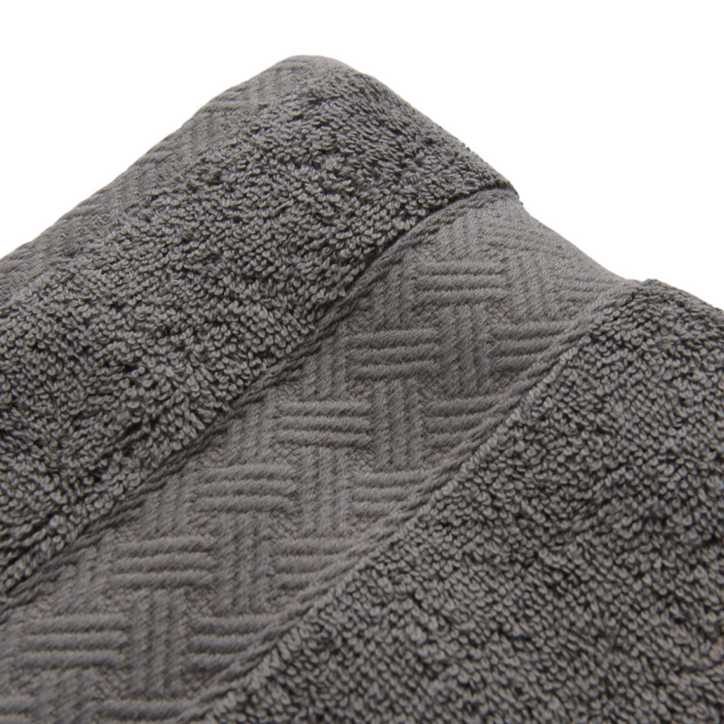 Close-up of a textured gray bath towel with a herringbone pattern.